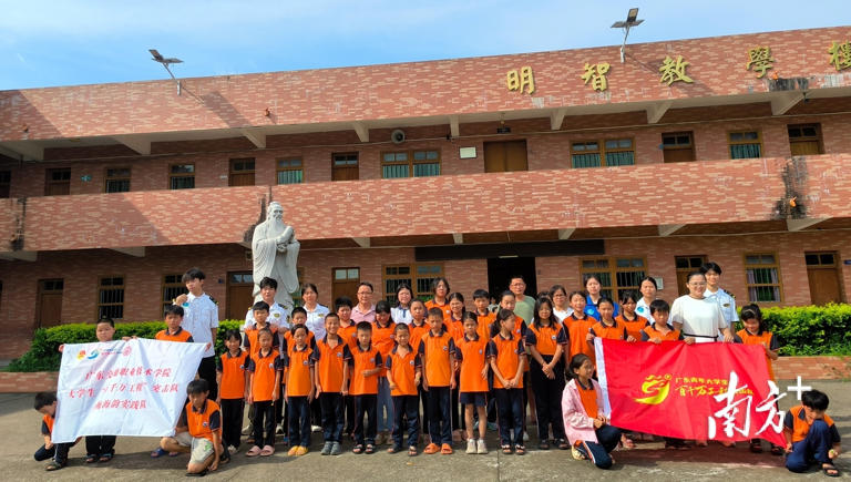 实践队师生与尖山村委代表、小学校长、小学生合影。