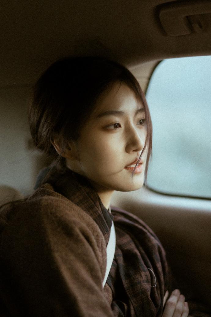 卢昱晓身穿褐色大衣 微倚车窗气质清冷
